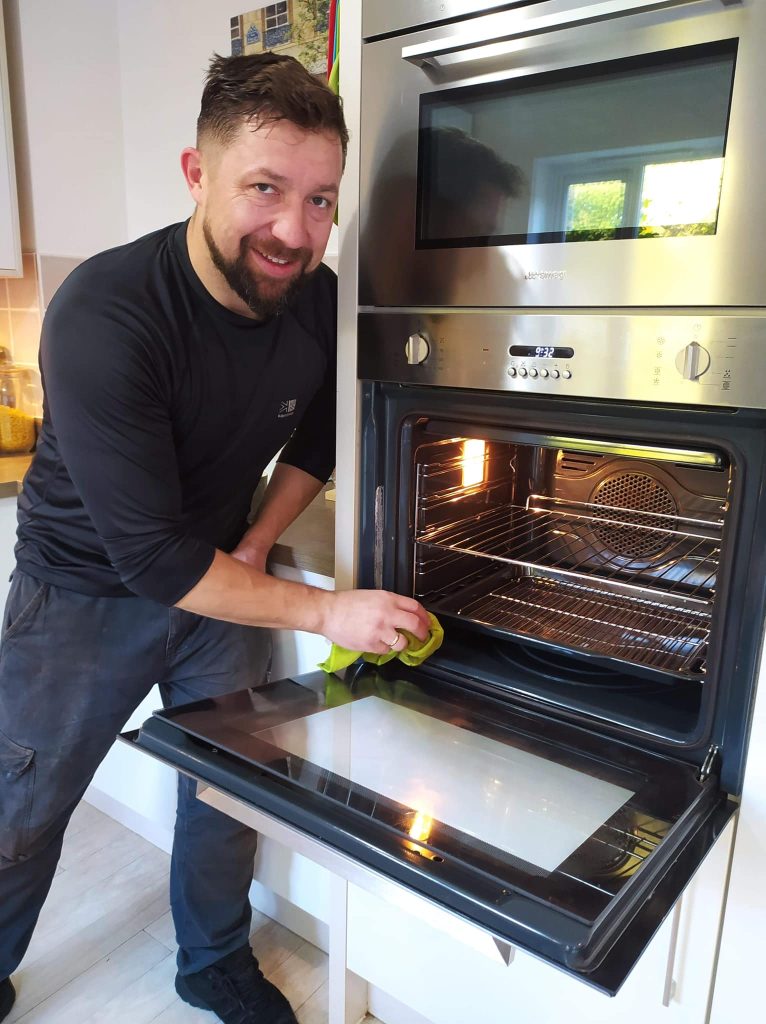 Professional oven cleaner at work