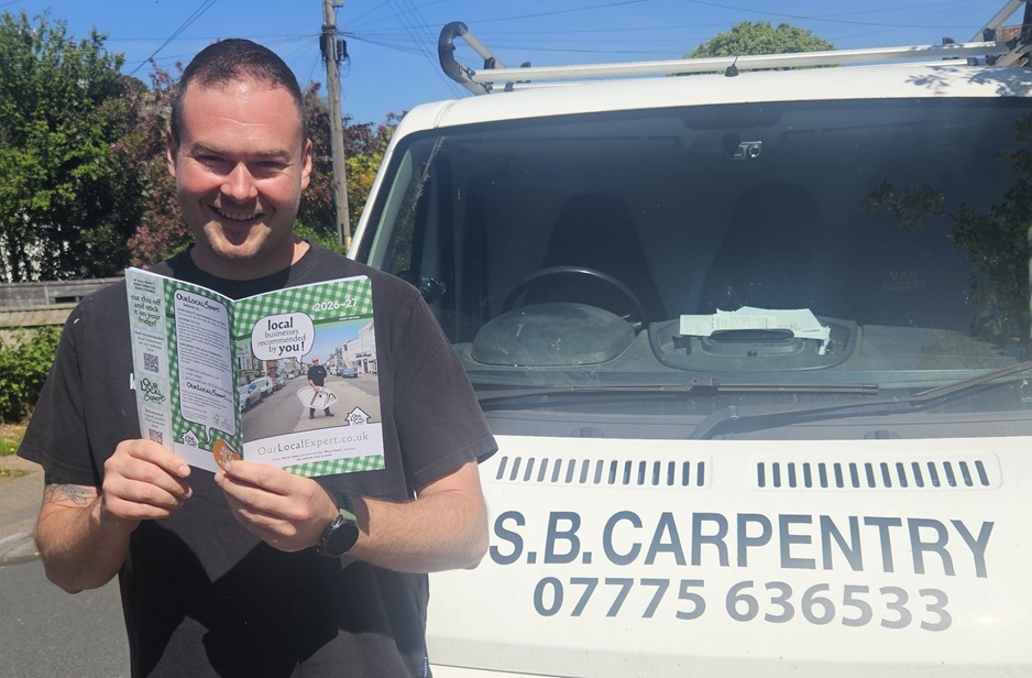 Stuart Bailey of SB Carpentry and Renovations, Honiton - holding printed edition of OurLocalExpert and smiling.