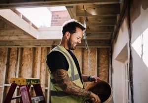 Smiling builder preparing mortar