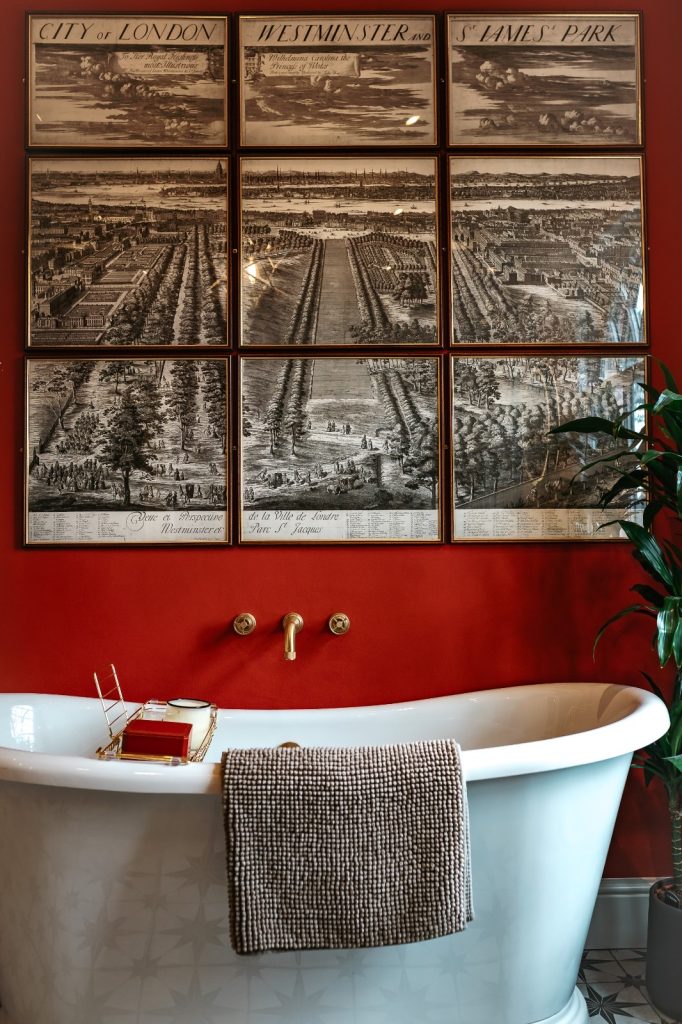 Stunning free standing bath with bold colour backdrop and crittall window screen