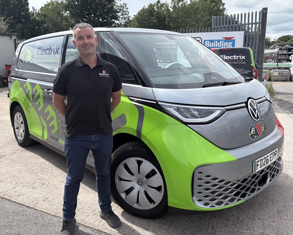 Smart Man standing proudly in front of Electric Van